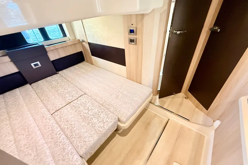 Slide: The Image of Interior cabin of 2016 Cranchi M44 HT yacht with elegant bedding and wood finish. - 126