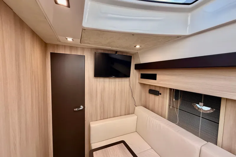 Slide: The Image of Interior of 2016 Cranchi M44 HT yacht with modern wood paneling and a mounted TV. - 94
