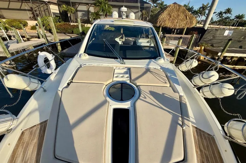 Slide: The Image of 2016 Cranchi M44 HT yacht docked, showcasing sleek design and spacious deck. - 150