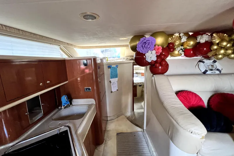 Slide: The Image of Interior of 2002 Sea Ray 450 Express Bridge with kitchen and festive decorations. - 23