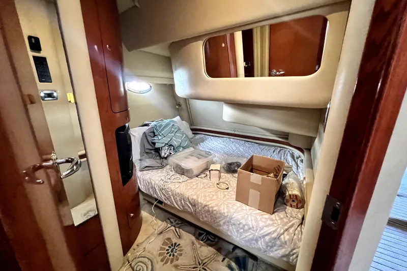 Slide: The Image of Interior cabin of 2002 Sea Ray 450 Express Bridge with bed and storage items. - 28