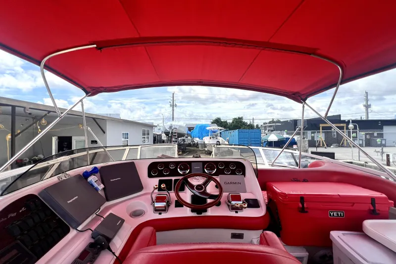 Slide: The Image of 2002 Sea Ray 450 Express Bridge helm with red canopy and modern navigation equipment. - 16