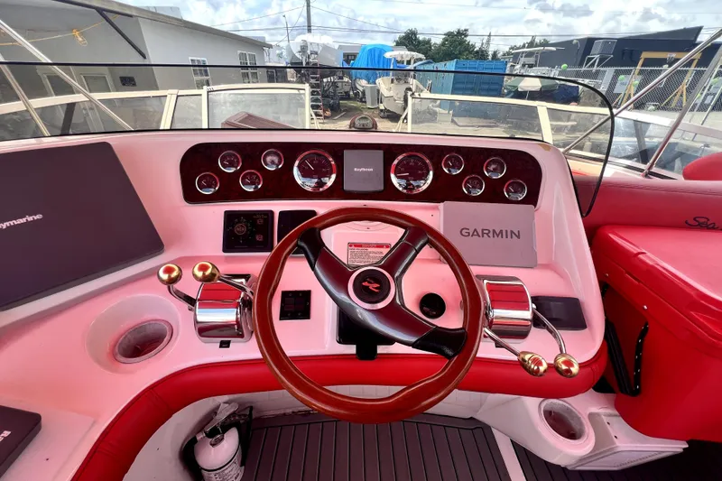 Slide: The Image of Helm of 2002 Sea Ray 450 Express Bridge with Garmin and Raymarine navigation systems. - 41