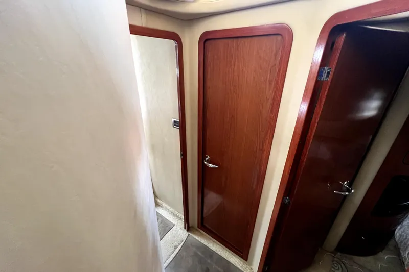 Slide: The Image of Interior hallway of 2002 Sea Ray 450 Express Bridge with wooden doors. - 39