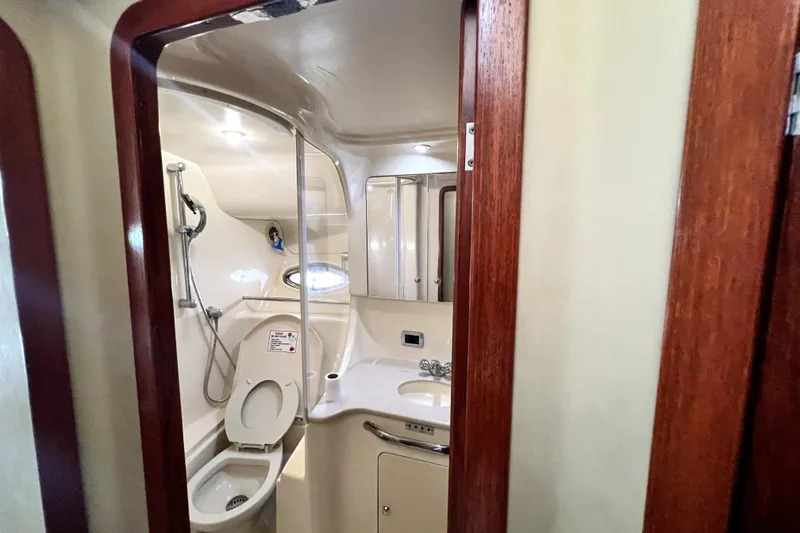 Slide: The Image of 2002 Sea Ray 450 Express Bridge bathroom with shower, toilet, and sink. - 38