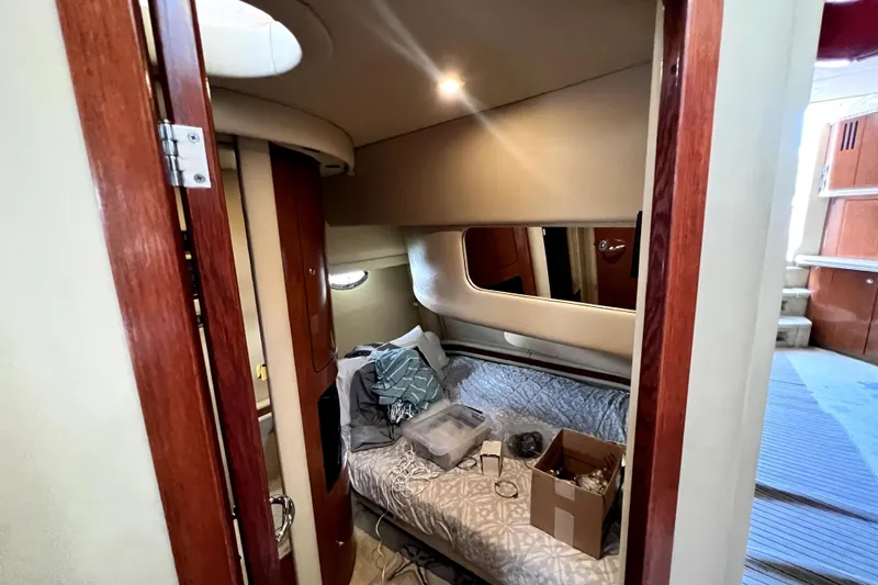 Slide: The Image of Interior cabin of 2002 Sea Ray 450 Express Bridge with bed and wooden accents. - 34