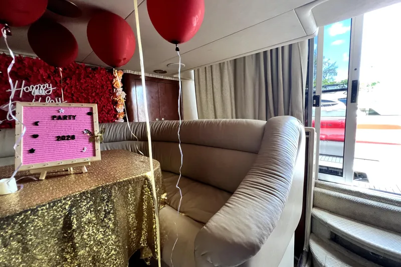Slide: The Image of Interior of 2002 Sea Ray 450 Express Bridge decorated for a party with balloons and sign. - 26