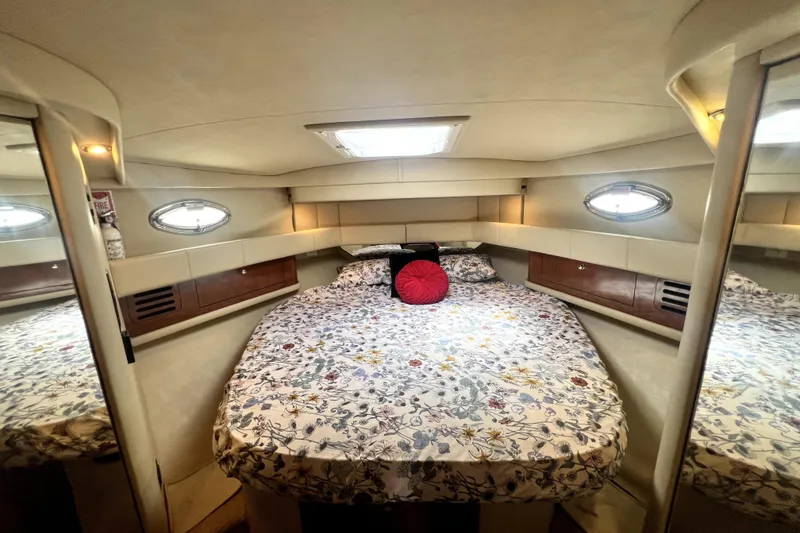 Slide: The Image of Luxurious cabin interior of 2002 Sea Ray 450 Express Bridge with floral bedding. - 14