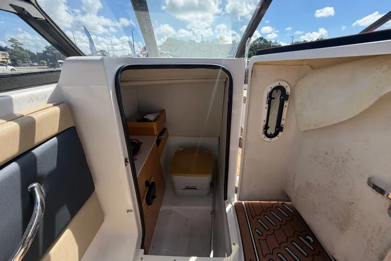 Slide: The Image of 2016 Glastron GT 245 boat interior cabin with storage and seating. - 32