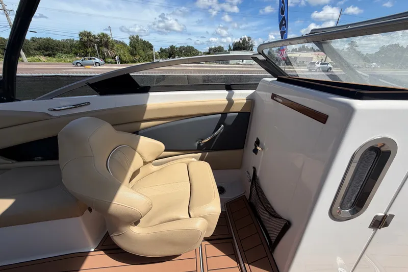 Slide: The Image of 2016 Glastron GT 245 boat interior with beige seating and sleek design. - 30