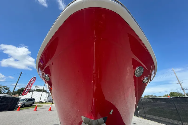 Slide: The Image of Red 2016 Glastron GT 245 boat front view under clear blue sky. - 9