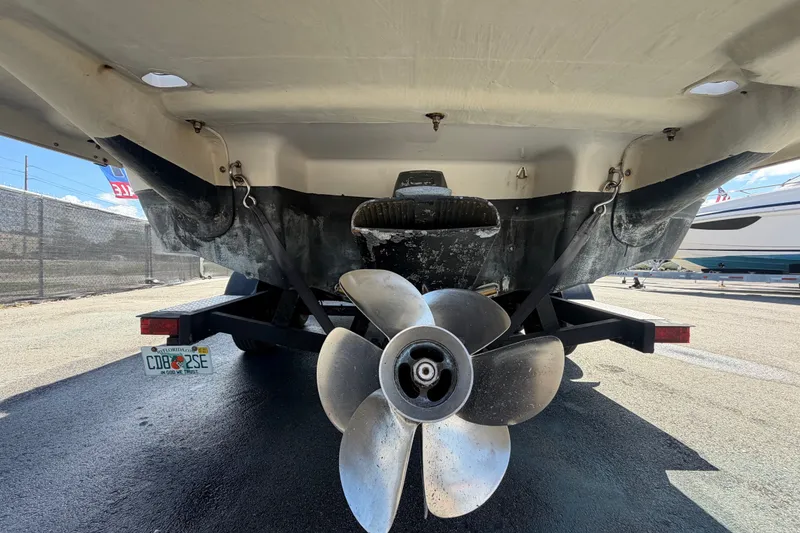 Slide: The Image of Rear view of a 2016 Glastron GT 245 boat on a trailer, showcasing the propeller. - 4