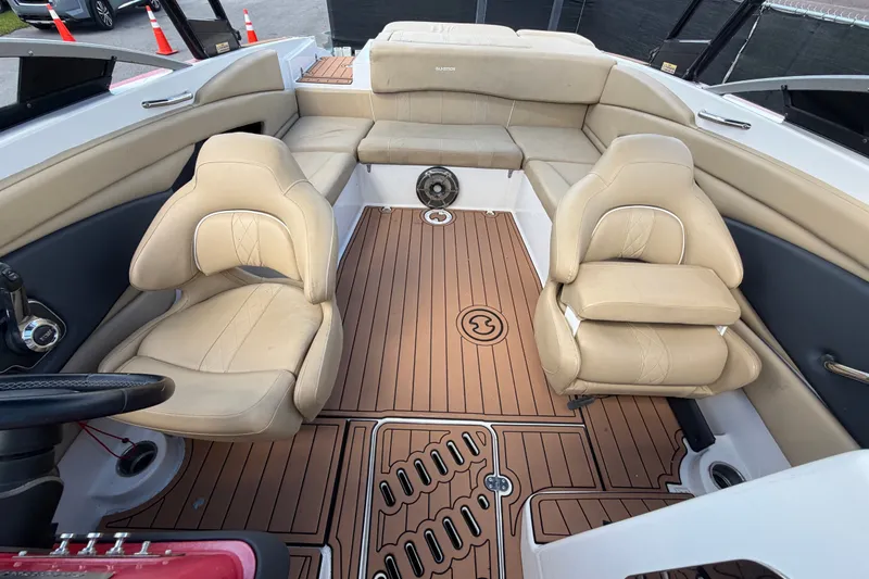 Slide: The Image of 2016 Glastron GT 245 boat interior with beige seating and wood-style flooring. - 59