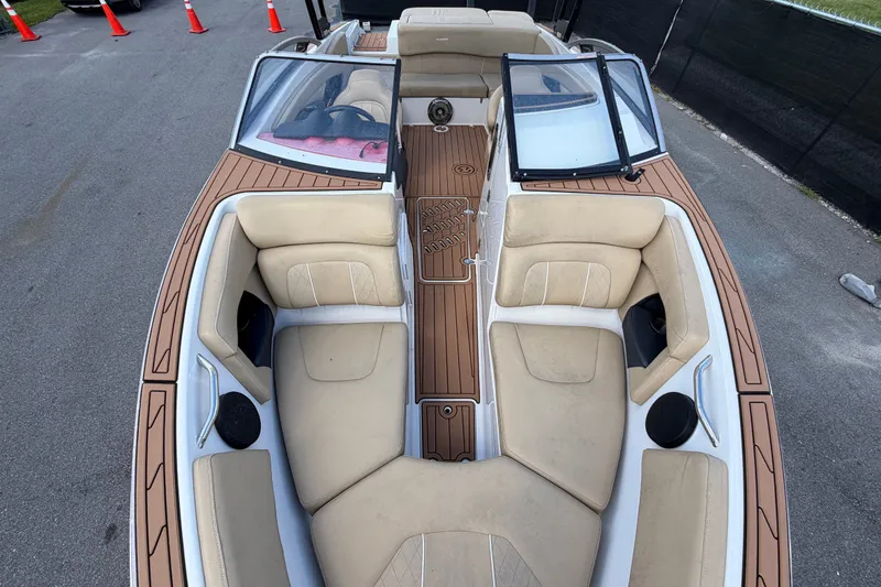 Slide: The Image of 2016 Glastron GT 245 boat interior with beige seating and wood accents. - 48