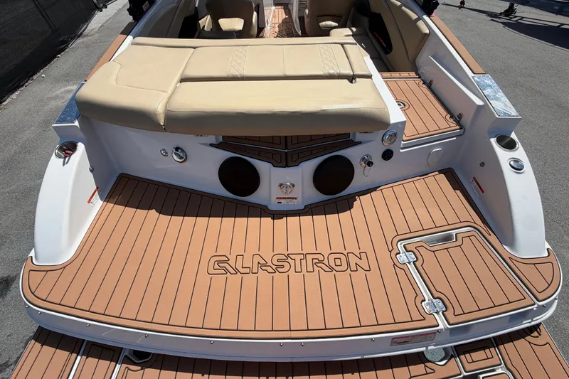 Slide: The Image of 2016 Glastron GT 245 boat with tan seating and teak-style deck. - 12