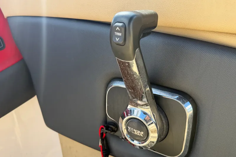Slide: The Image of Throttle control lever on a 2016 Glastron GT 245 boat dashboard. - 29