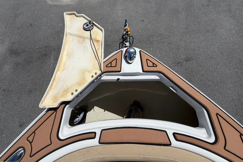 Slide: The Image of The 2016 Glastron GT 245 features an open bow hatch with storage space beneath. - 46
