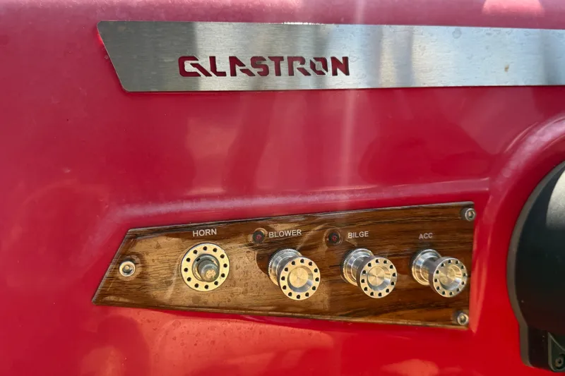 Slide: The Image of Control panel of a 2016 Glastron GT 245 boat with labeled switches. - 27
