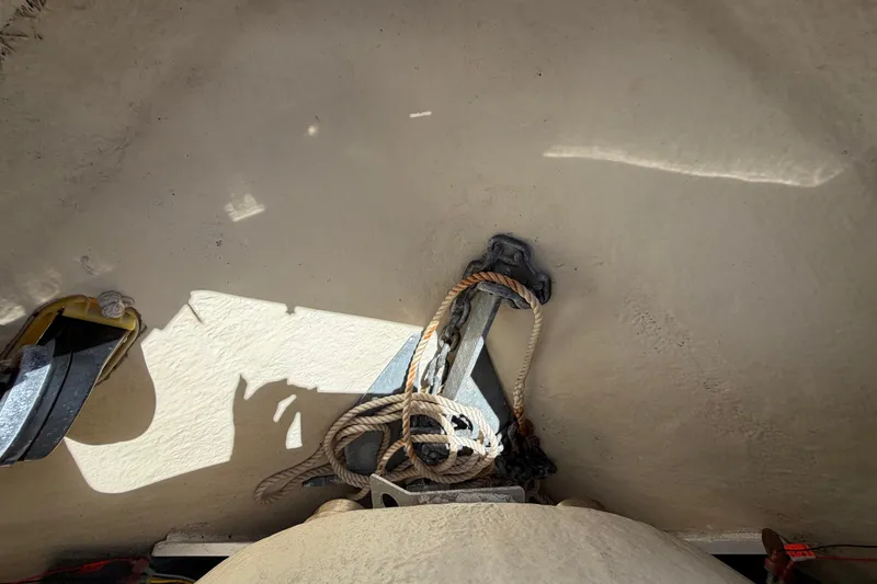 Slide: The Image of An anchor with rope in a boat storage compartment. - 47