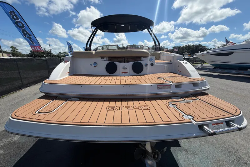 Slide: The Image of 2016 Glastron GT 245 boat with teak deck, showcased under a sunny sky. - 3