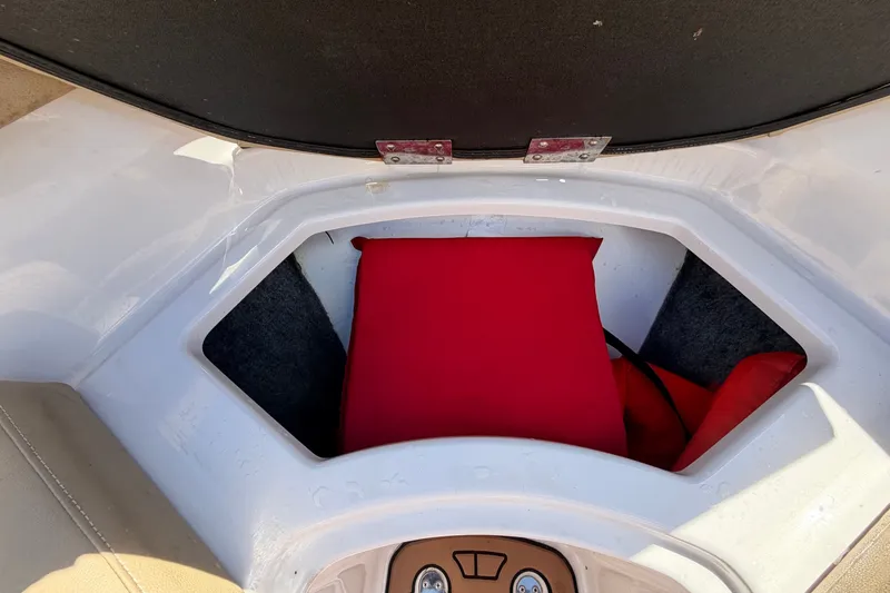 Slide: The Image of A red cushion in a storage compartment of a 2016 Glastron GT 245 boat. - 45