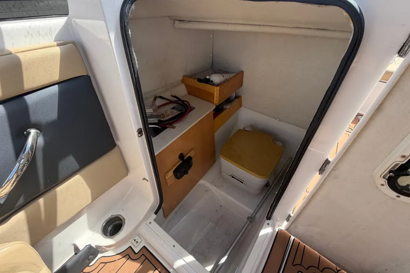 Slide: The Image of Interior storage compartment of a 2016 Glastron GT 245 boat with shelves and equipment. - 33