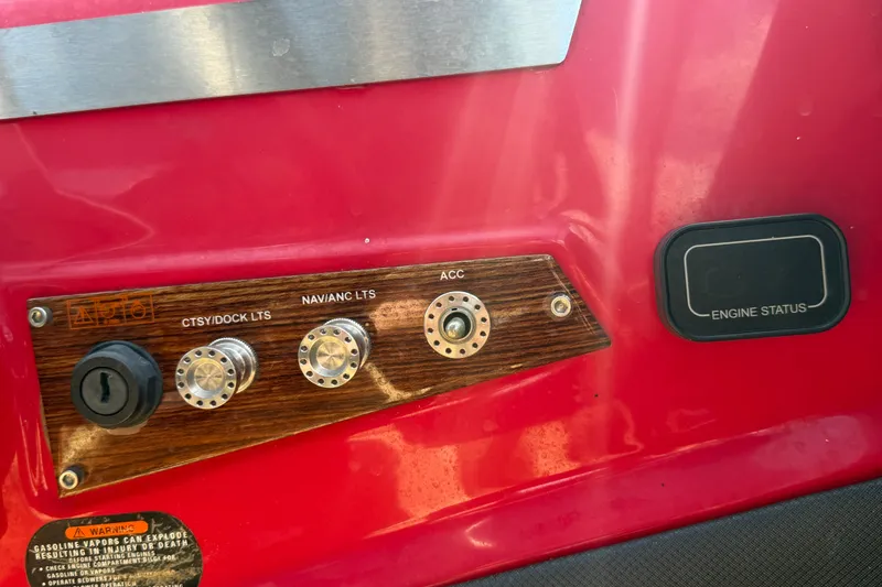 Slide: The Image of Control panel of a 2016 Glastron GT 245 boat with light switches and engine status. - 28