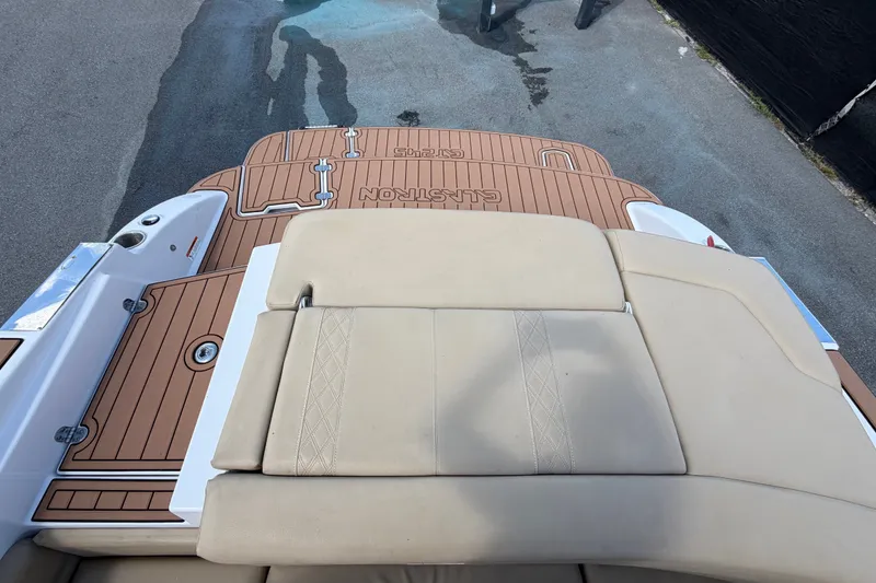 Slide: The Image of 2016 Glastron GT 245 boat with tan upholstery and teak-style deck. - 76