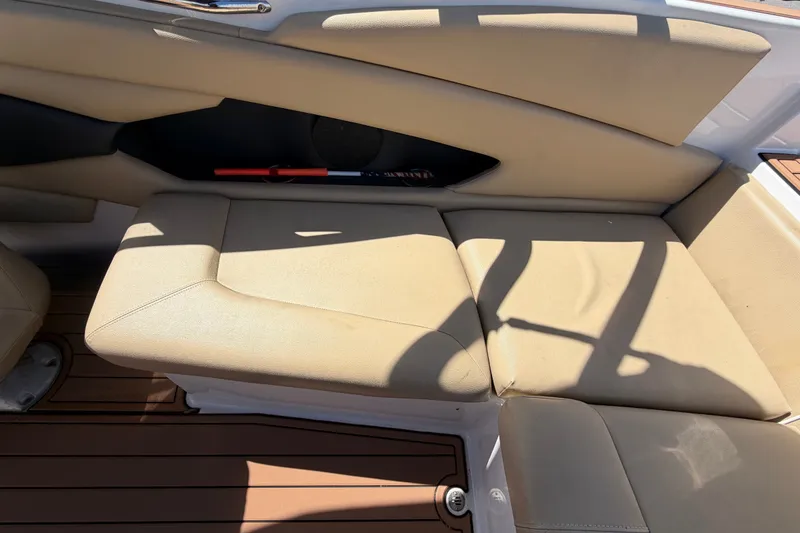 Slide: The Image of Beige seating on 2016 Glastron GT 245 boat with wooden flooring. - 63