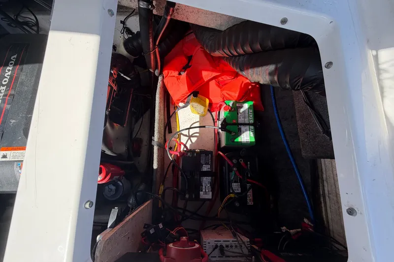 Slide: The Image of Engine compartment of a 2016 Glastron GT 245 boat, showing battery and wiring. - 74