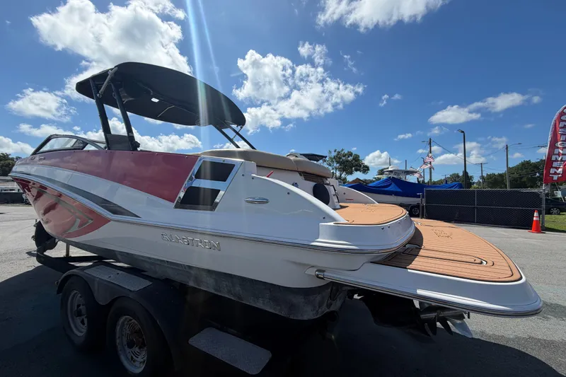 Slide: The Image of 2016 Glastron GT 245 boat on trailer under clear blue sky. - 6