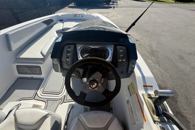 Slide: The Image of De afbeelding toont de cockpit van een Scarab 165 boot uit 2016 met een modern stuur. - 19