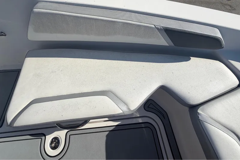 Slide: The Image of Close-up of a 2016 Scarab 165 boat with white and gray upholstery and modern design. - 30