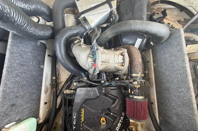 Slide: The Image of Engine compartment of a 2016 Scarab 165 boat, featuring Rotax engine components. - 48