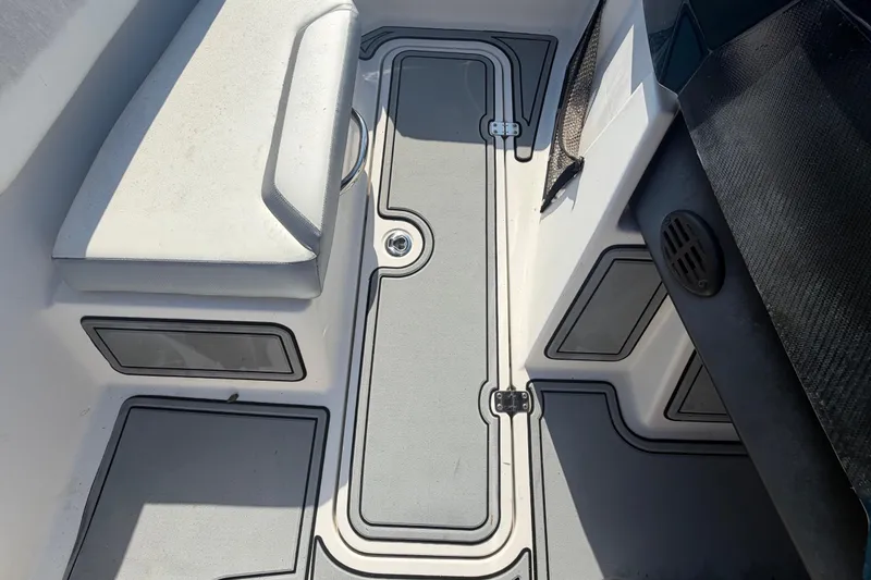 Slide: The Image of Interior view of a 2016 Scarab 165 boat, featuring sleek seating and storage compartments. - 27