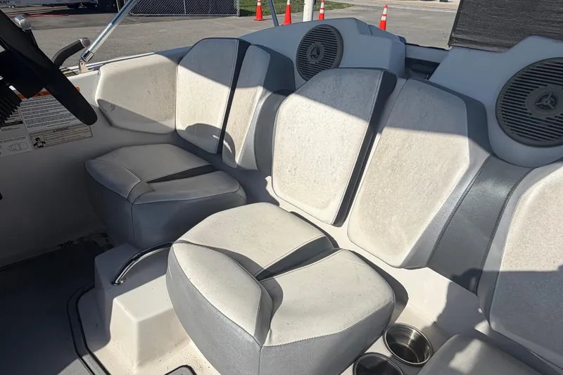 Slide: The Image of Interior seating of a 2016 Scarab 165 boat with gray upholstery and cup holders. - 42