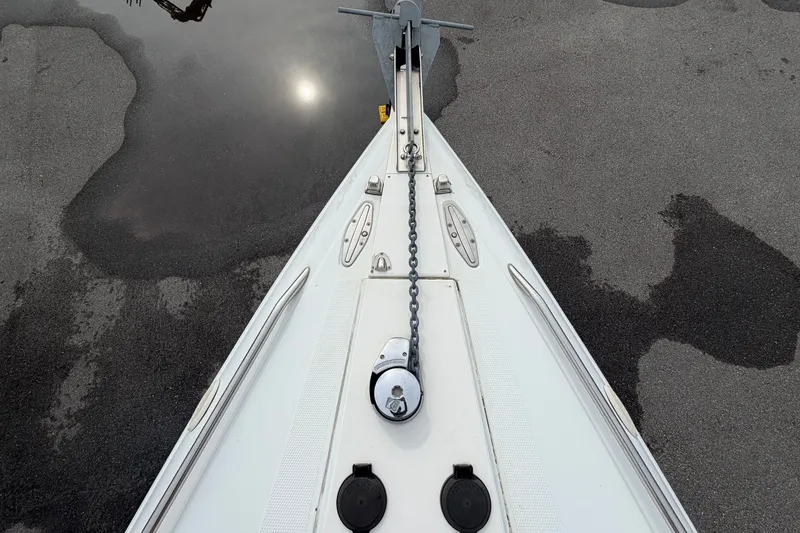 Slide: The Image of Bow view of 2001 Baja 340 Islander Outboard with anchor chain and water reflection. - 45