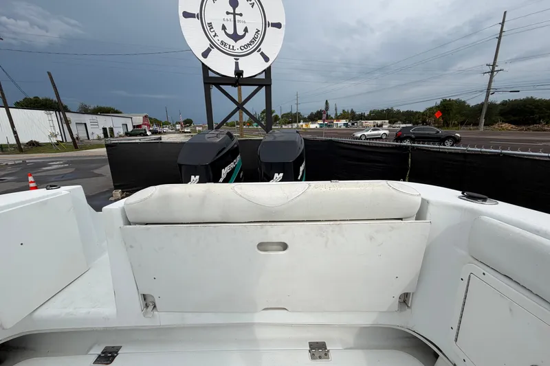 Slide: The Image of 2001 Baja 340 Islander Outboard boat with dual Mercury engines, docked near a road. - 64