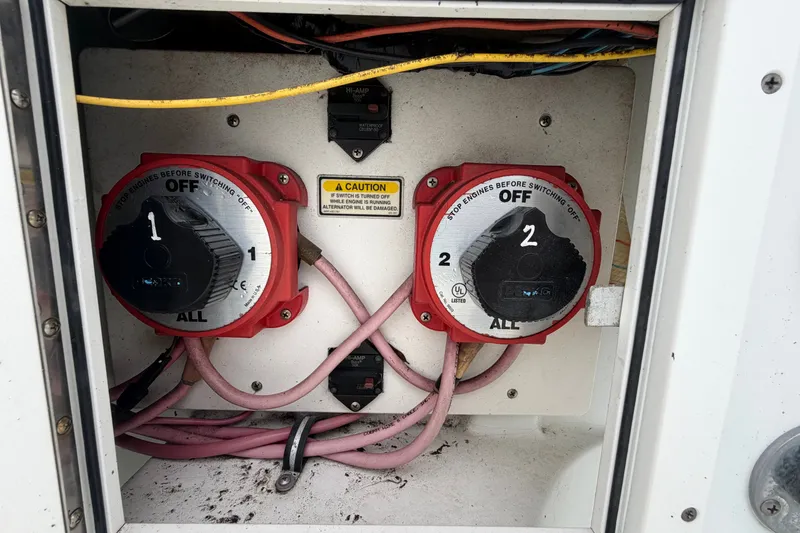 Slide: The Image of Battery switches on a 2001 Baja 340 Islander Outboard boat, labeled "1" and "2". - 69