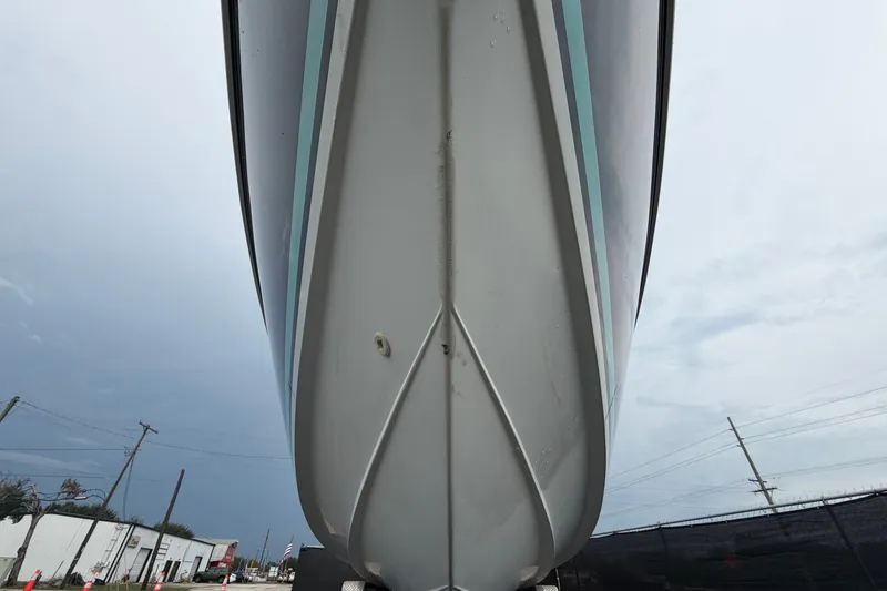 Slide: The Image of 2001 Baja 340 Islander Outboard boat hull, viewed from below, against cloudy sky. - 13