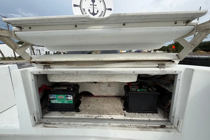 Slide: The Image of Open battery compartment of a 2001 Baja 340 Islander Outboard boat, showing two batteries. - 67