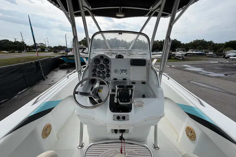 Slide: The Image of 2001 Baja 340 Islander Outboard boat cockpit with steering wheel and control panel. - 23