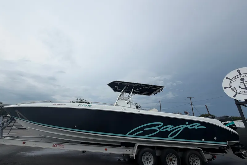 Slide: The Image of 2001 Baja 340 Islander Outboard boat on trailer under cloudy sky. - 10