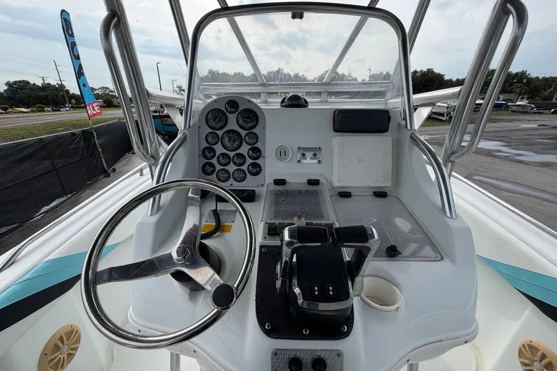 Slide: The Image of 2001 Baja 340 Islander Outboard boat dashboard with steering wheel and control panel. - 24