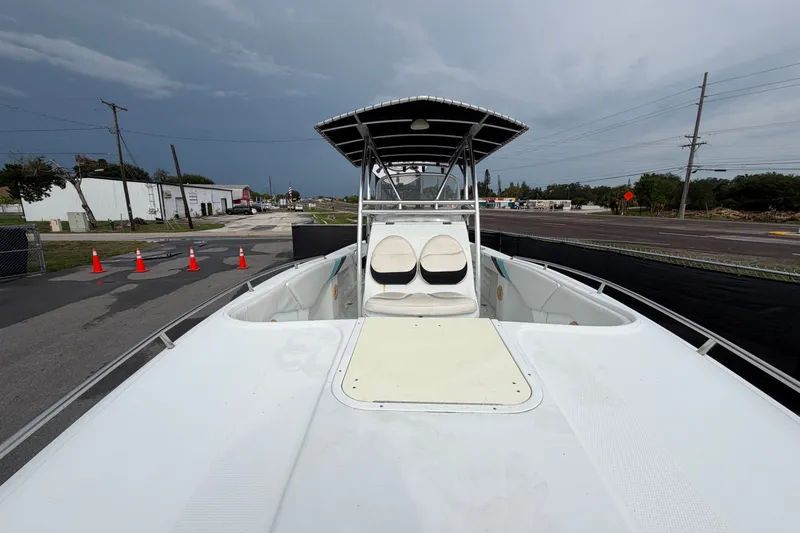 Slide: The Image of 2001 Baja 340 Islander Outboard boat with T-top, parked on a street under cloudy skies. - 46