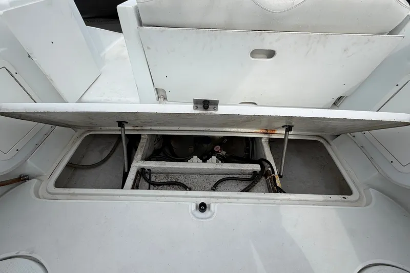 Slide: The Image of Open engine compartment of a 2001 Baja 340 Islander Outboard boat, showing internal components. - 62