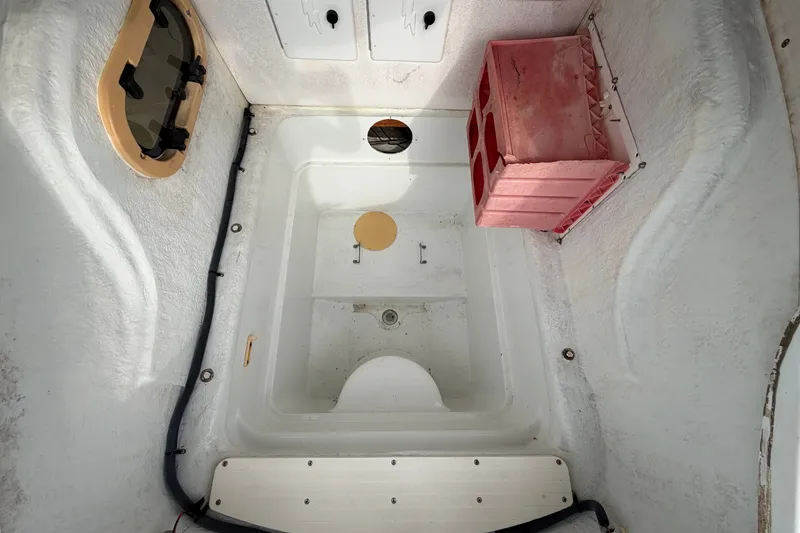 Slide: The Image of 2001 Baja 340 Islander Outboard interior with storage compartments and red crate. - 51