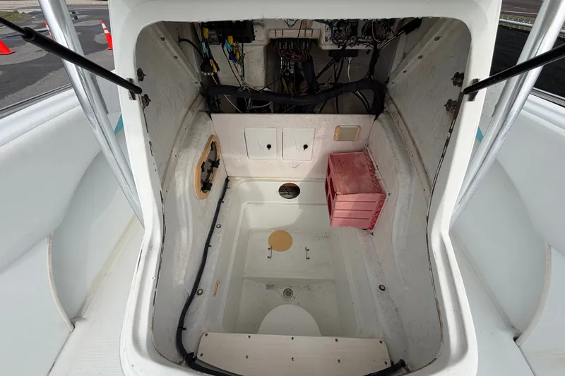 Slide: The Image of Interior view of a 2001 Baja 340 Islander Outboard boat, showcasing storage and wiring. - 49