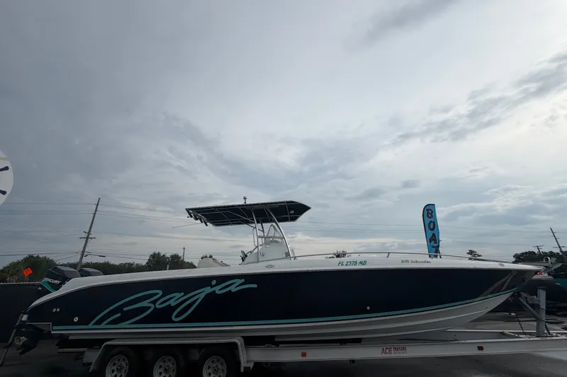 Slide: The Image of 2001 Baja 340 Islander Outboard boat on trailer under cloudy sky. - 1