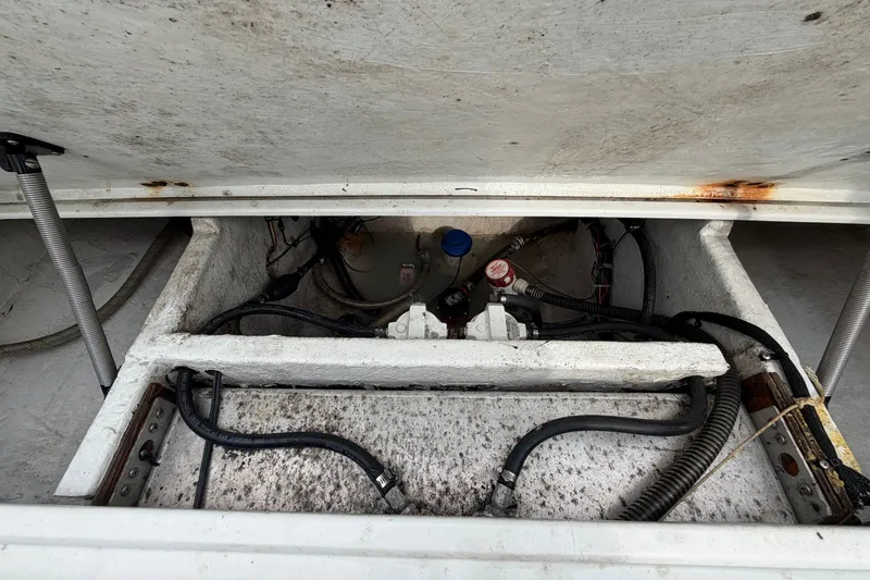 Slide: The Image of 2001 Baja 340 Islander Outboard engine compartment with visible hoses and components. - 63